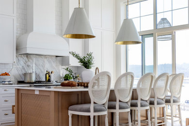 Beach style single-wall light wood floor, beige floor and exposed beam open concept kitchen photo in Vancouver with a farmhouse sink, shaker cabinets and an island