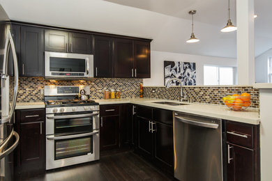 Enclosed kitchen - mid-sized u-shaped dark wood floor enclosed kitchen idea in San Francisco with an undermount sink, recessed-panel cabinets, dark wood cabinets, brown backsplash, stainless steel appliances and no island