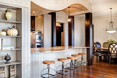 Inspiration for a large mediterranean u-shaped medium tone wood floor kitchen remodel in Charlotte with stainless steel appliances and two islands