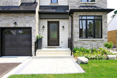 Example of a mid-sized transitional entryway design in Toronto with a dark wood front door