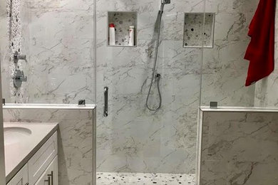 Inspiration for a large transitional gray tile, white tile and marble tile marble floor and gray floor alcove shower remodel in Los Angeles with a hinged shower door, shaker cabinets, white cabinets, white walls, an undermount sink, solid surface countertops and gray countertops
