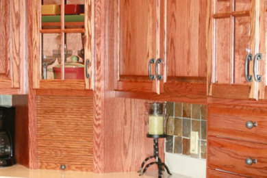 Inspiration for a kitchen remodel in Other with glass-front cabinets, medium tone wood cabinets and black appliances