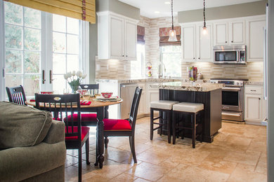 Example of a mid-sized transitional u-shaped travertine floor open concept kitchen design in Orange County with a double-bowl sink, recessed-panel cabinets, white cabinets, laminate countertops, multicolored backsplash, stone tile backsplash, stainless steel appliances and an island