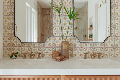 Inspiration for a large mediterranean master yellow tile and terra-cotta tile double-sink corner shower remodel in Miami with light wood cabinets, white walls, a hinged shower door, white countertops, a niche and a built-in vanity