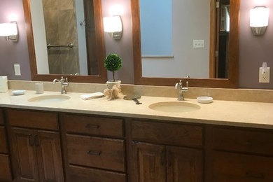 Inspiration for a large timeless master porcelain tile and brown floor bathroom remodel in Other with raised-panel cabinets, medium tone wood cabinets, purple walls, an undermount sink, quartz countertops and beige countertops