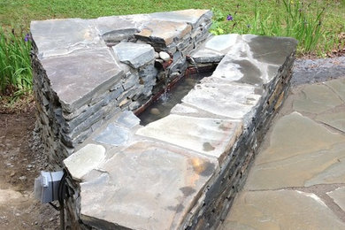 This is an example of a modern backyard stone landscaping in New York.