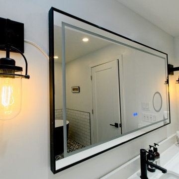 Vintage Black Wall Sconces Around a Large Vanity Mirror | Downtown Toronto
