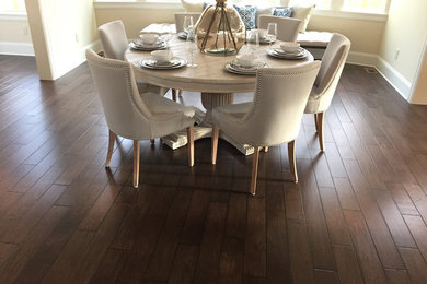 Inspiration for a large traditional dining room in San Diego with beige walls, dark hardwood floors, no fireplace and brown floor.