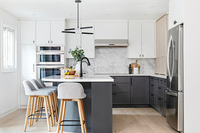 Large danish l-shaped light wood floor eat-in kitchen photo in Toronto with an undermount sink, shaker cabinets, light wood cabinets, quartz countertops, gray backsplash, porcelain backsplash, stainless steel appliances, an island and white countertops
