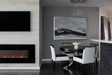 Inspiration for a mid-sized contemporary kitchen/dining combo in Atlanta with grey walls, dark hardwood floors, a standard fireplace and a stone fireplace surround.