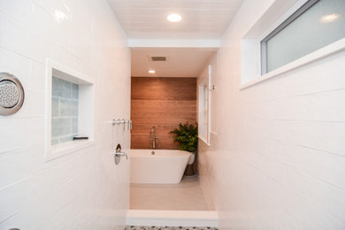 This is an example of a large transitional master bathroom in Boston with flat-panel cabinets, medium wood cabinets, a freestanding tub, a double shower, a two-piece toilet, white tile, subway tile, grey walls, porcelain floors, an undermount sink, engineered quartz benchtops, grey floor, an open shower, white benchtops, a niche, a single vanity and a freestanding vanity.