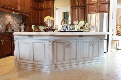 Eat-in kitchen - large traditional l-shaped porcelain tile and beige floor eat-in kitchen idea in Austin with a farmhouse sink, raised-panel cabinets, gray cabinets, quartzite countertops, stainless steel appliances, an island and white countertops
