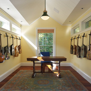 Mid-sized traditional study room in San Francisco with yellow walls, dark hardwood floors, no fireplace, a freestanding desk and brown floor.