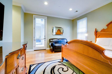 Inspiration for a mid-sized craftsman master light wood floor and brown floor bedroom remodel in Other with green walls and no fireplace