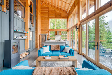 Beach style formal and open concept gray floor living room photo in Seattle with gray walls and a wood stove