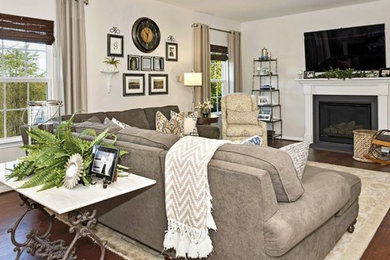 Large transitional open concept dark wood floor family room photo in DC Metro with gray walls, a standard fireplace, a wood fireplace surround and a wall-mounted tv