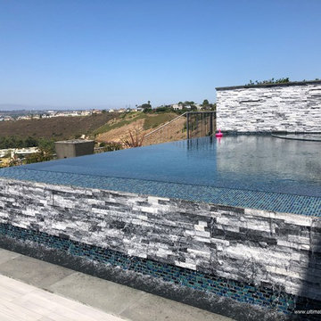 Los Angeles - Contemporary Hillside Pool & Spa with Colored Water Spillways