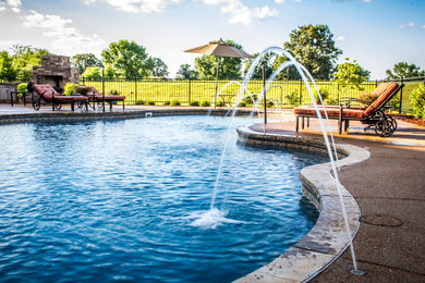 Inspiration for a large transitional backyard concrete and custom-shaped pool fountain remodel in Chicago