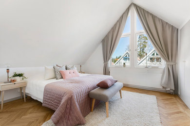 Inspiration for a contemporary master bedroom in Stockholm with white walls, medium hardwood floors and no fireplace.