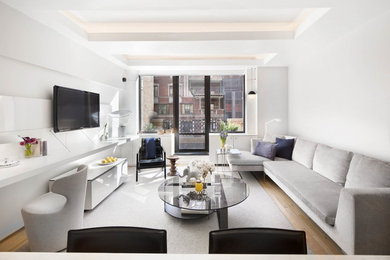 Living room - small contemporary formal and enclosed light wood floor and beige floor living room idea in New York with white walls, a wall-mounted tv and no fireplace