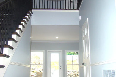 Example of a large trendy dark wood floor hallway design in Birmingham with blue walls