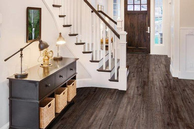 Example of a mid-sized cottage dark wood floor entryway design in St Louis with white walls and a dark wood front door