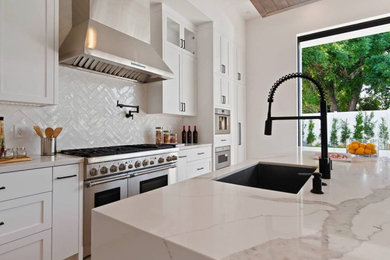Kitchen - mid-sized modern vinyl floor kitchen idea in Seattle with an undermount sink, shaker cabinets, white backsplash, ceramic backsplash, stainless steel appliances, an island and white countertops