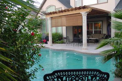 Inspiration for a large backyard stone and custom-shaped natural pool fountain remodel in Houston