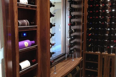 Large minimalist porcelain tile wine cellar photo in Sacramento
