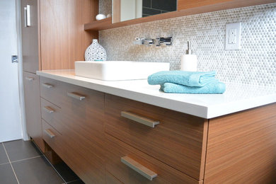 Example of a trendy white tile and mosaic tile ceramic tile and gray floor bathroom design in Montreal with white walls, a vessel sink, quartzite countertops, flat-panel cabinets and medium tone wood cabinets