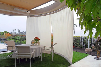 Example of an island style patio design in Orange County