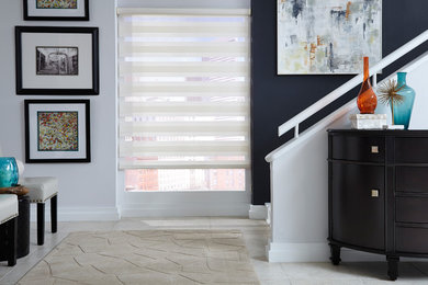Inspiration for a contemporary ceramic tile and beige floor hallway remodel in Other with multicolored walls