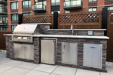 Mid-sized trendy rooftop outdoor kitchen deck photo in New York with no cover