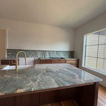 Green quartzite kitchen with full-height slab backsplash
