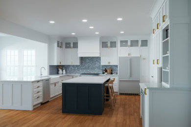 Design ideas for an expansive l-shaped kitchen pantry in DC Metro with flat-panel cabinets, white cabinets and an island.