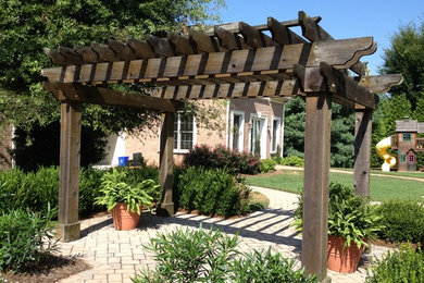 Inspiration for a timeless backyard stone patio kitchen remodel in Charlotte with a pergola