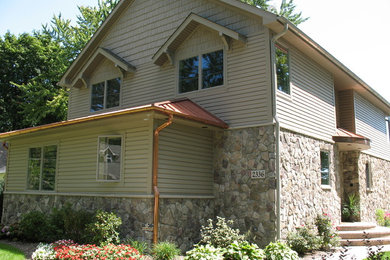 Large elegant beige two-story mixed siding exterior home photo in Detroit