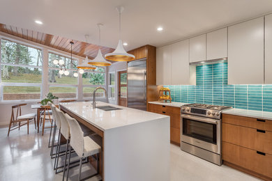 Photo of a mid-sized midcentury eat-in kitchen in Other with blue splashback, stainless steel appliances, with island, a double-bowl sink, flat-panel cabinets, white cabinets, quartzite benchtops, ceramic splashback and grey floor.