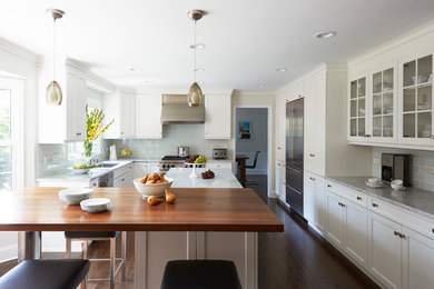 Eat-in kitchen - large transitional l-shaped dark wood floor and brown floor eat-in kitchen idea in Chicago with a single-bowl sink, recessed-panel cabinets, white cabinets, granite countertops, white backsplash, porcelain backsplash, stainless steel appliances and an island