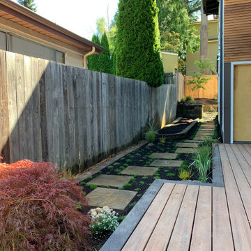 Deck platform, fence, hardscape, garden and planters.