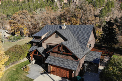Inspiration for a large timeless two-story house exterior remodel in Other with a shingle roof and a gray roof