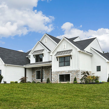 Angled view of a modern farmhouse with black windows