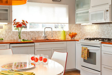 1950s eat-in kitchen photo in San Diego with mosaic tile backsplash, flat-panel cabinets, white cabinets, quartz countertops, beige backsplash, white appliances and orange countertops