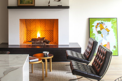 1960s open concept light wood floor living room photo in DC Metro with a standard fireplace, a brick fireplace and white walls