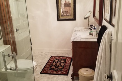 Inspiration for a mid-sized transitional 3/4 gray tile, white tile and subway tile marble floor and white floor corner shower remodel in Portland with a two-piece toilet, white walls, an undermount sink, marble countertops and a hinged shower door
