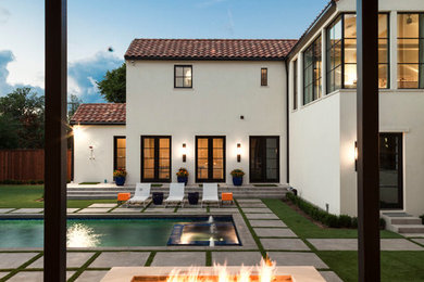 Inspiration for an expansive mediterranean backyard patio in Dallas with a fire feature and concrete pavers.