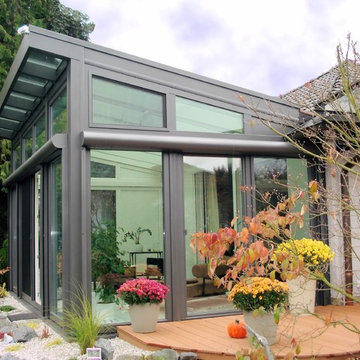 Moderner Wintergarten mit umgekehrtem Pultdach