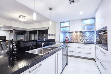 Contemporary l-shaped eat-in kitchen in Perth with a double-bowl sink, flat-panel cabinets, white cabinets, metallic splashback, stainless steel appliances and with island.