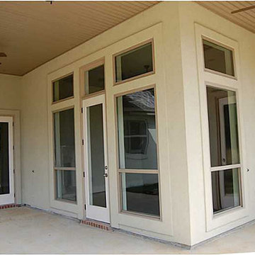 Rear covered patio with beadboard ceilings and ceiling fans