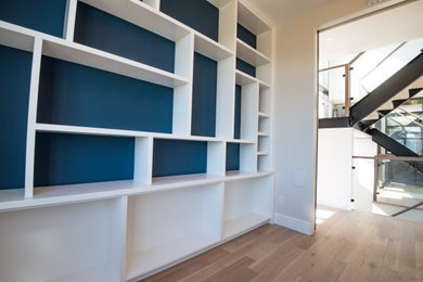 Mid-sized trendy brown floor home office library photo in Other with white walls
